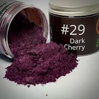 a jar of dark cherry powder next to a jar