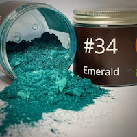 a jar of emerald green powder next to a jar