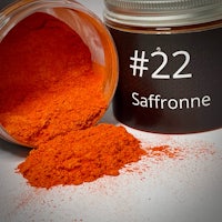 a jar of orange powder next to a jar with the word 22 saffron